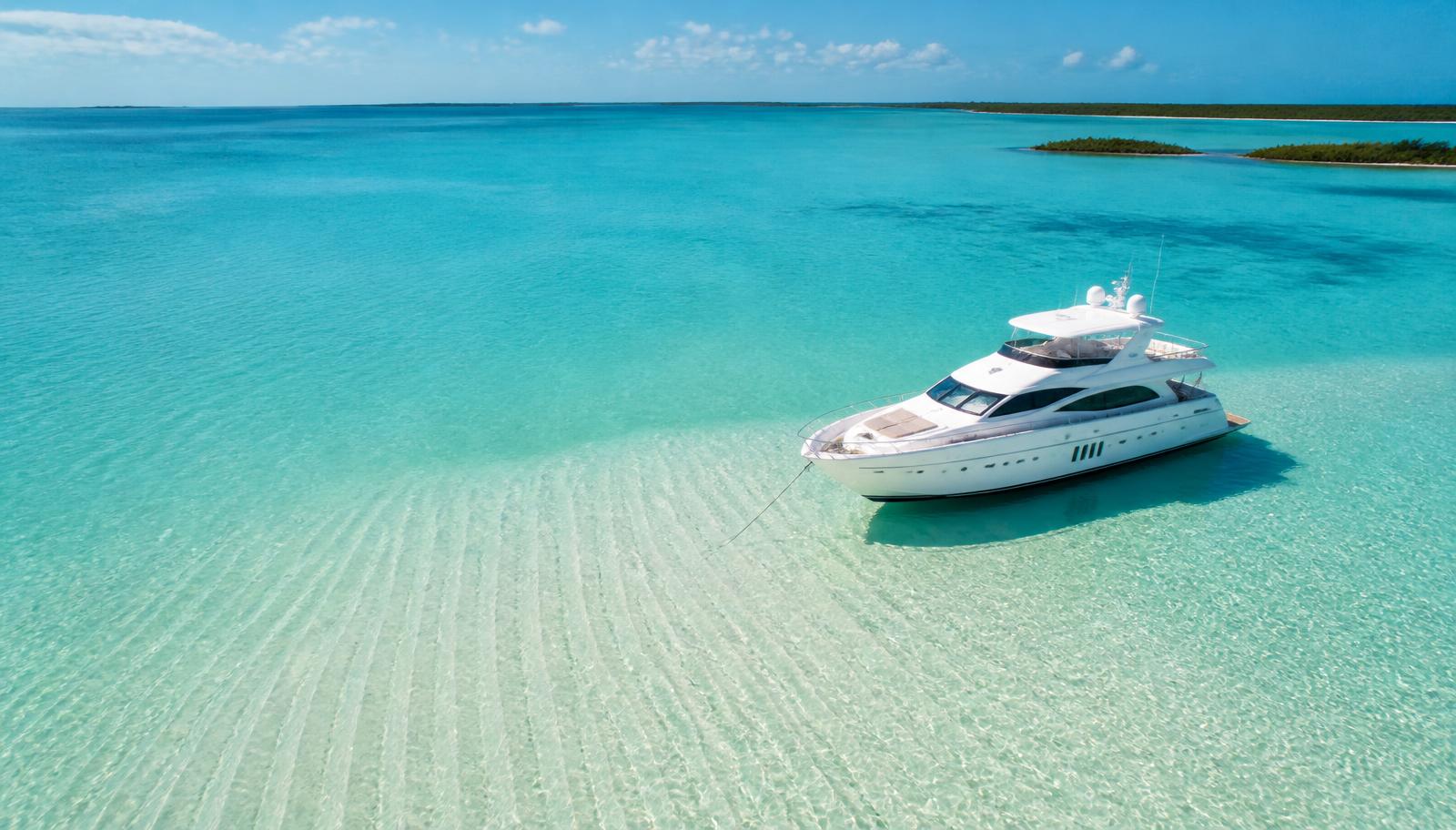 Aerial view of a yacht anchored over a clear Florida sandbar